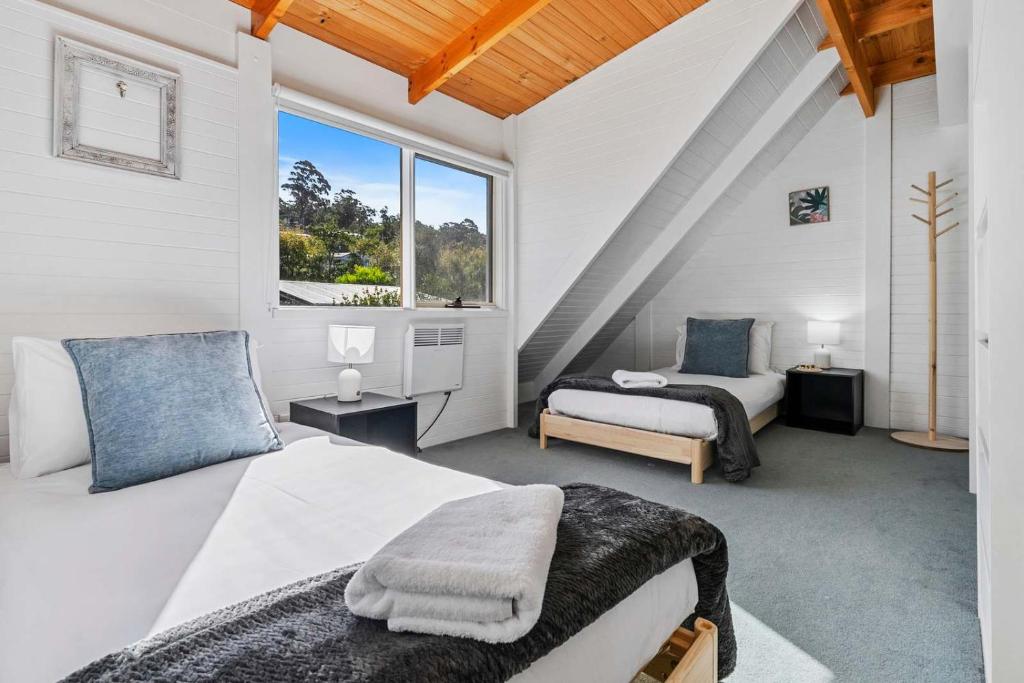 a bedroom with two beds and a window at Ocean Views 20kms from CBD Sleeps 10 in Kingston Beach