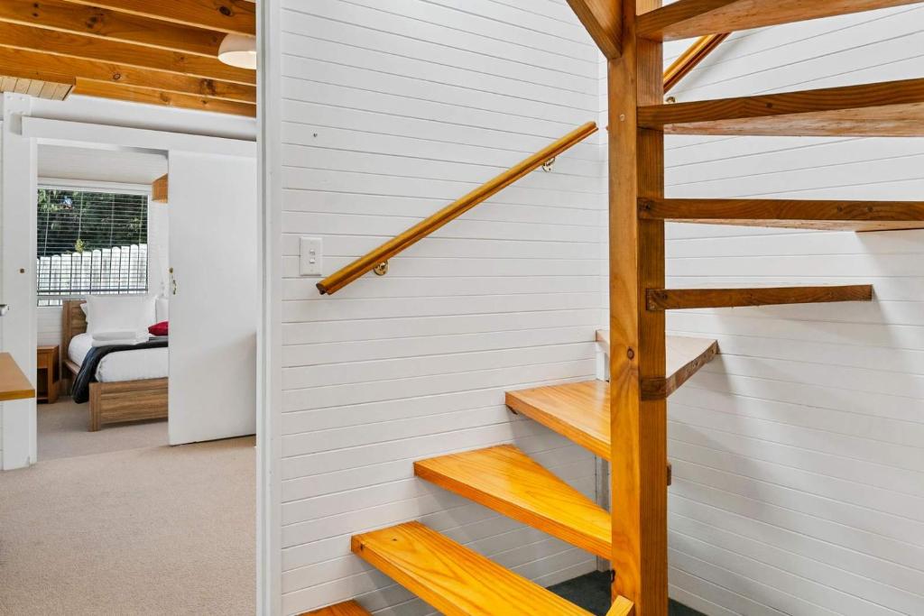 a staircase in a house with white walls at Ocean Views 20kms from CBD Sleeps 10 in Kingston Beach
