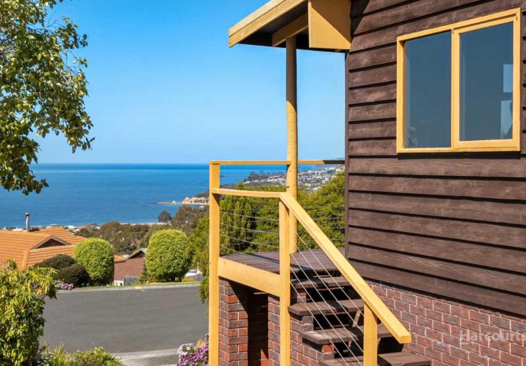 a wooden staircase on the side of a house at Ocean Views 20kms from CBD Sleeps 10 in Kingston Beach