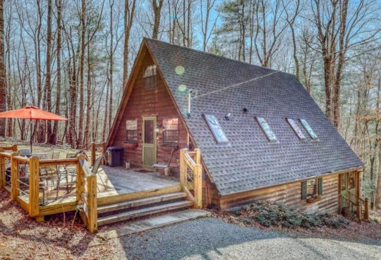 a small log cabin with a porch and a deck at Bearly Behavin in Blue Ridge