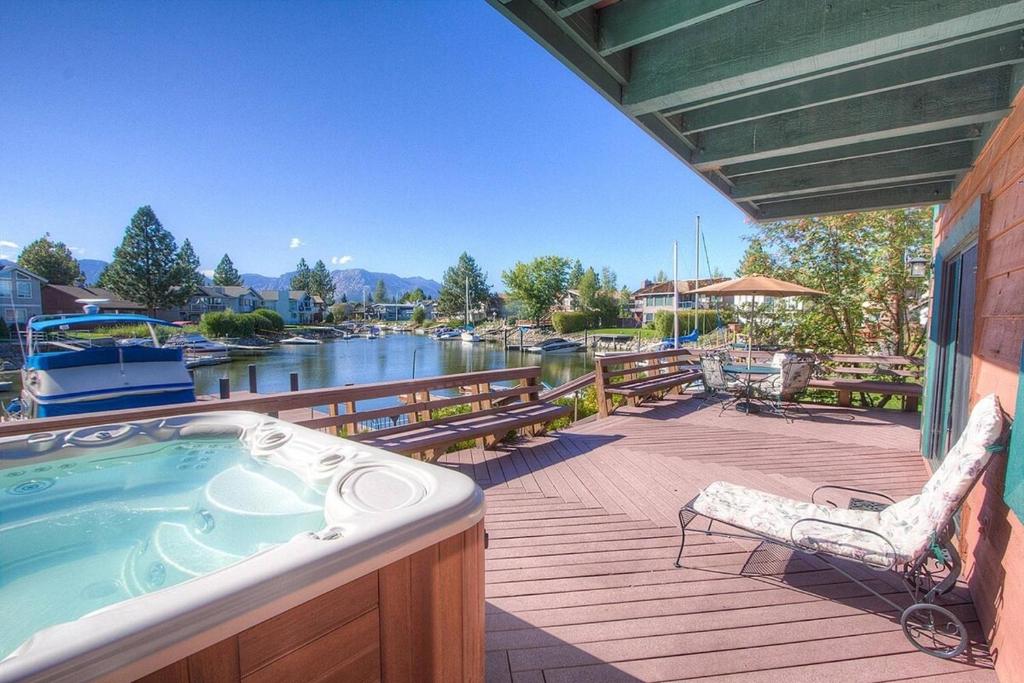 a deck with a hot tub and a chair at TKH1226 - Emerald Lodge in South Lake Tahoe