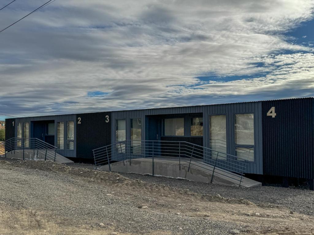 a building with the number four on the side at Simple Aparts in El Calafate