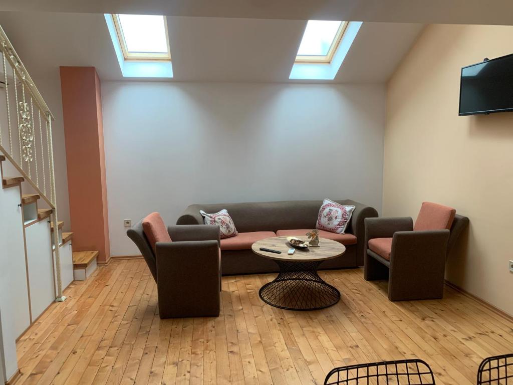 ein Wohnzimmer mit Sofa und Tisch in der Unterkunft Center Apartments The Quiet Luxury 7 in Plowdiw