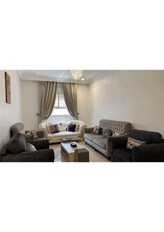 a living room with two couches and a window at abha condo in Abha
