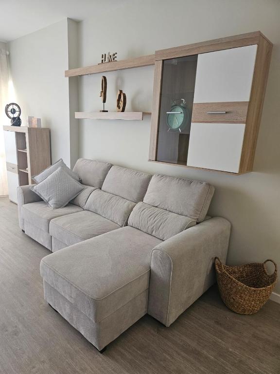 a living room with a couch and a mirror at Gratitude Apartment in Funchal