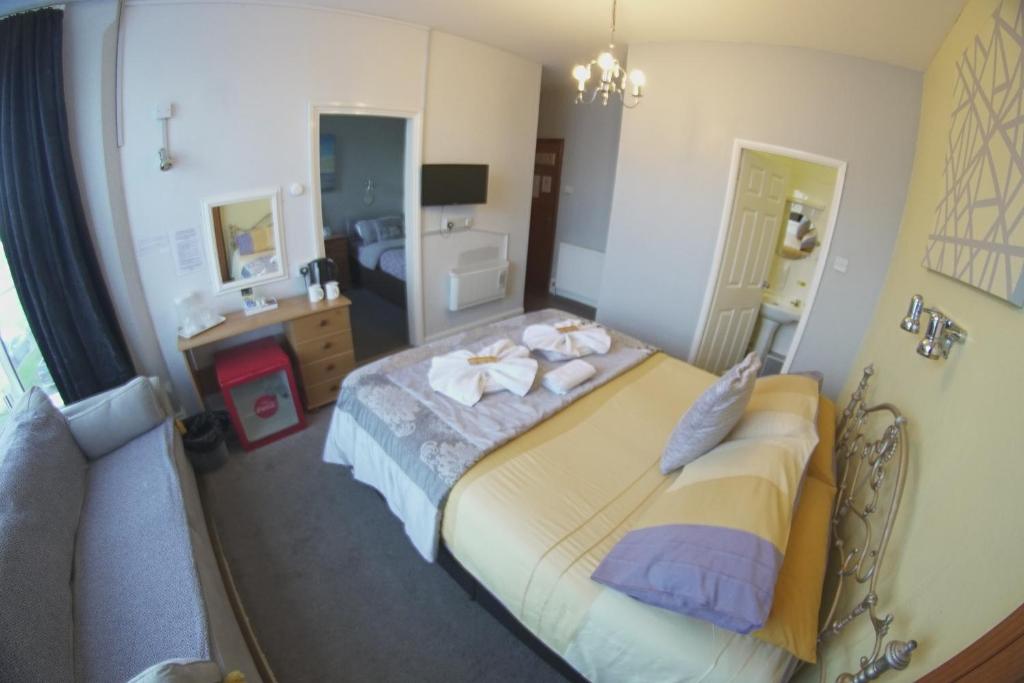 a bedroom with a bed and a sink in it at The Eastleigh in Skegness