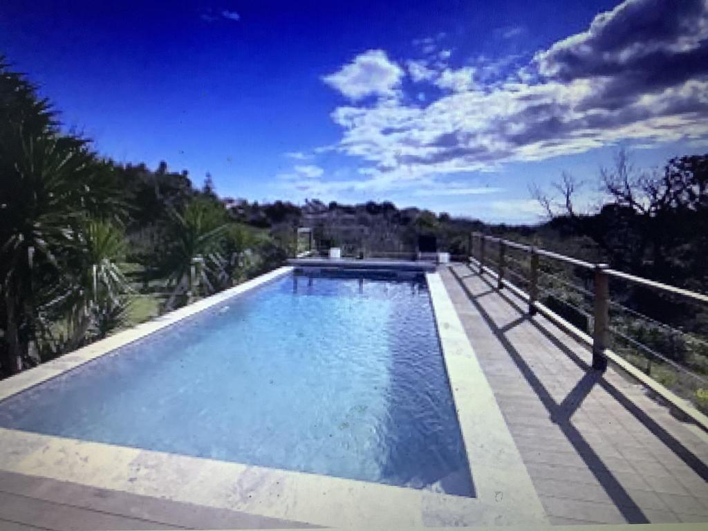 une grande piscine assise à côté d'une clôture dans l'établissement Casa fiurita bastia, à Bastia