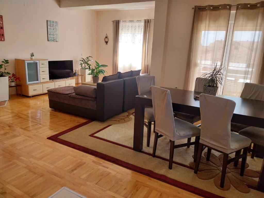 a living room with a table and a couch at Sorin Apartments Gevgelija in Gevgelija