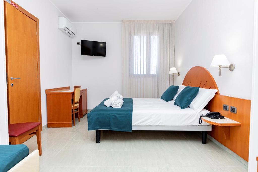 Postel nebo postele na pokoji v ubytování Hotel Alba