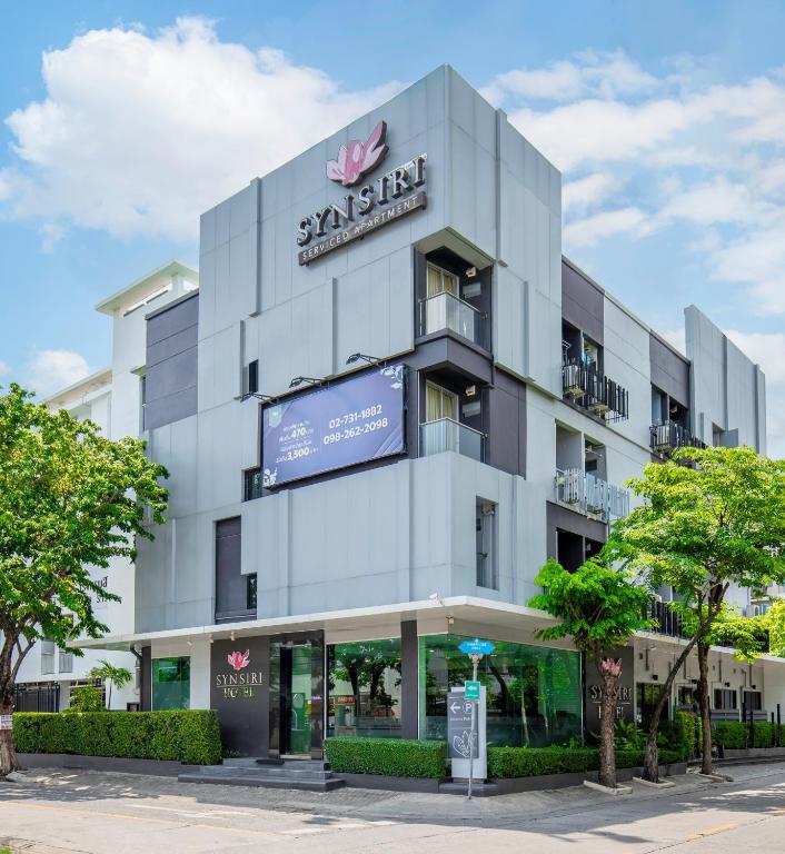 a large white building with a sign on it at Synsiri Ladprao 130 in Ban Bang Toei (1)
