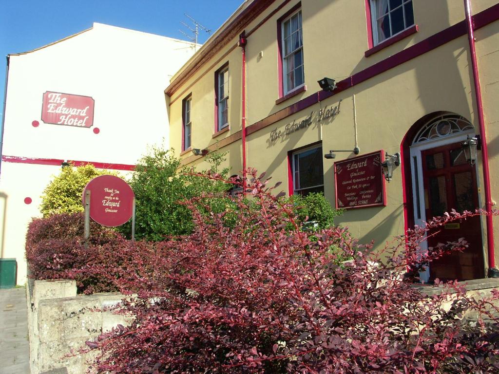 a building with a sign in front of it at Edward Hotel in Gloucester