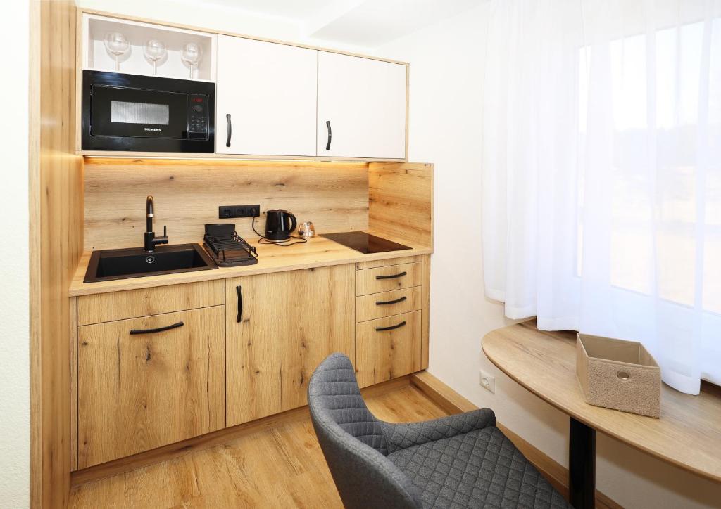 Kuchyň nebo kuchyňský kout v ubytování Hotel Erlebnis Wald