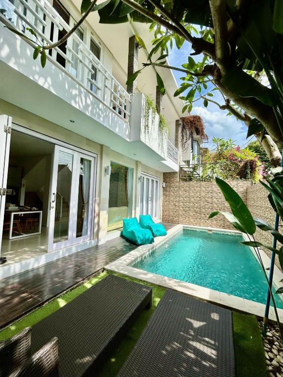 a swimming pool in front of a house at Villa VELIA private pool in Badung