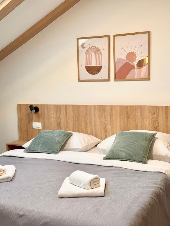 two beds sitting next to each other with towels on them at Cloud9 Airport Rooms in Močići