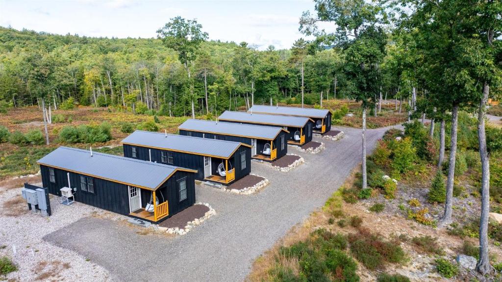 an overhead view of a row of tiny homes in a forest at CHICKADEE LIMIT 4 in North Sebago