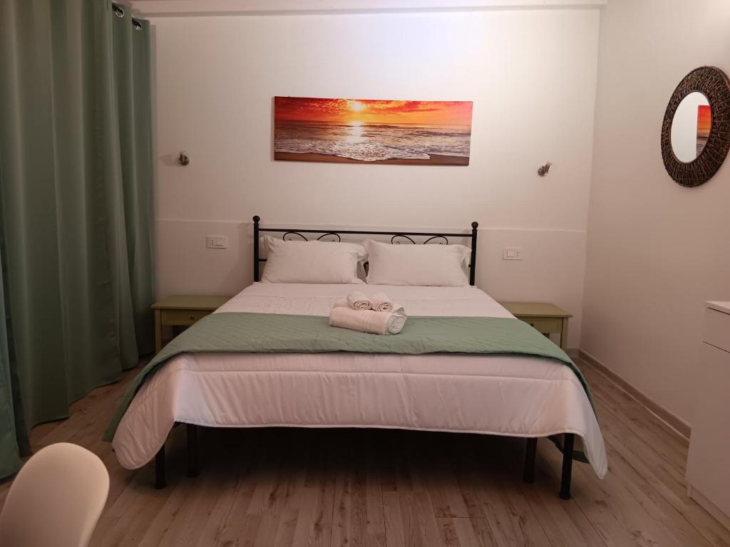 Postel nebo postele na pokoji v ubytování L'Attico Villasimius