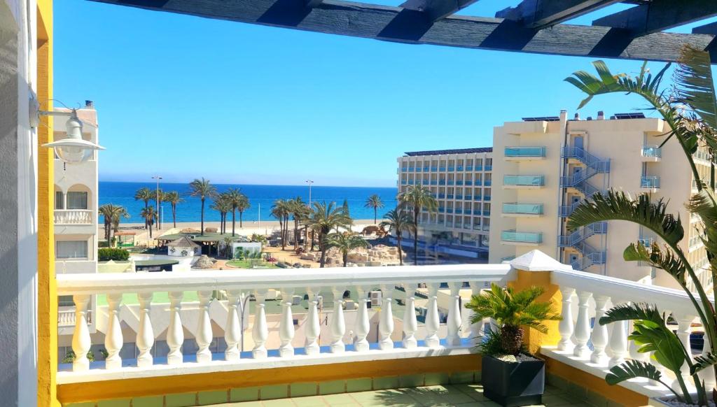 a balcony with a view of the beach and buildings at Apartamento Mar de Roquetas in Roquetas de Mar
