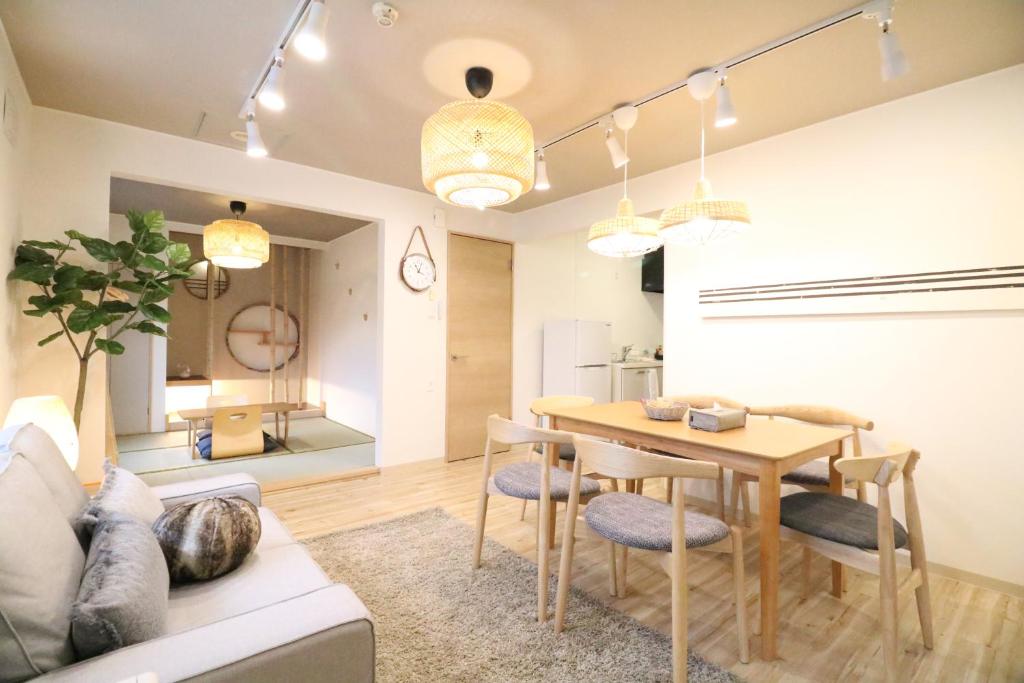 a dining room and living room with a table and chairs at Sky Court 717 in Ōdōri