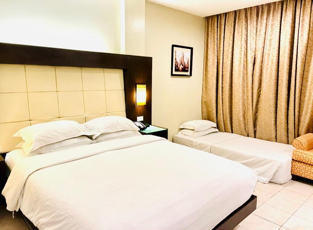 Postel nebo postele na pokoji v ubytování Circle Inn Hotel and Suites Bacolod