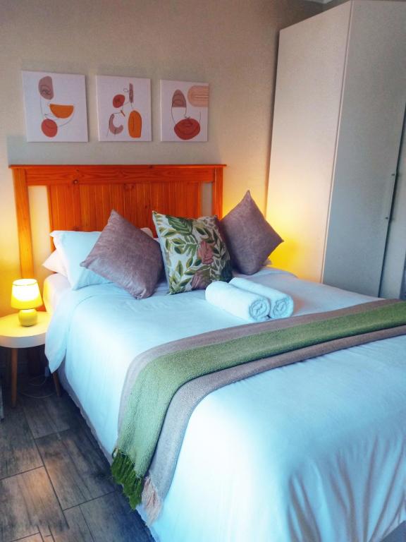 a bedroom with a large bed with pillows on it at Matria Nest in East London