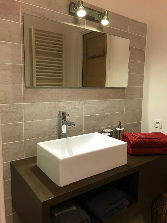 une salle de bain avec un lavabo blanc et un miroir dans l'établissement Gite Vanisa, à Sainte-Maxime