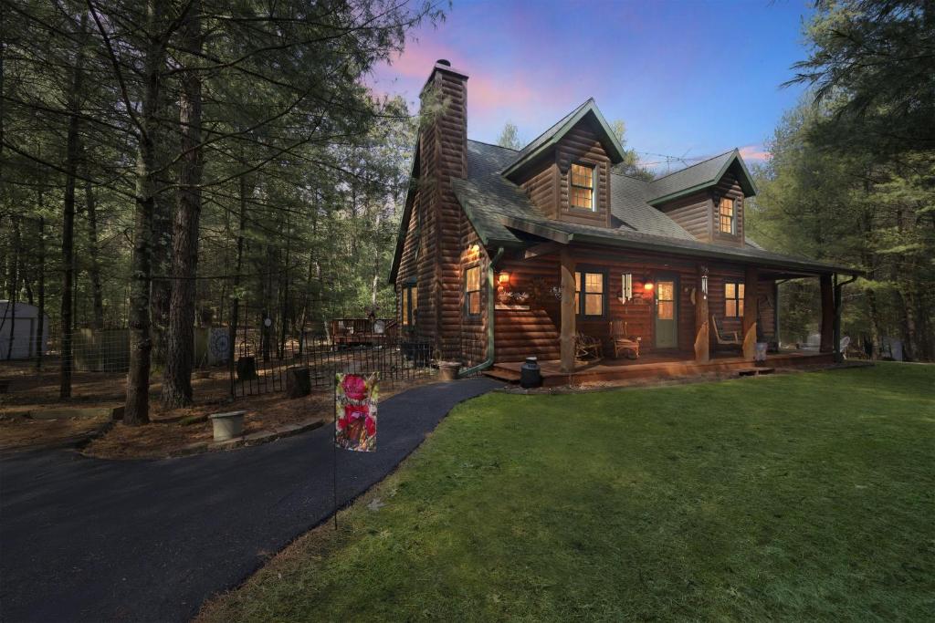 a log cabin with a grass yard in front of it at Woodlands Cabin Retreat in Oxford cabin in Oxford
