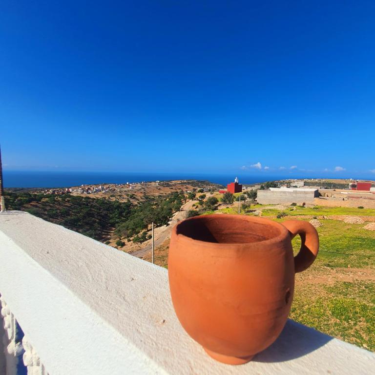 an orange vase sitting on the ledge of a balcony at The View in Taghazout
