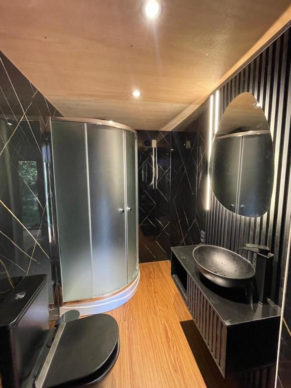 a bathroom with a shower and a sink in it at El Domo del ALF La Paz entre el bosque y el mar II in Sauce de Portezuelo