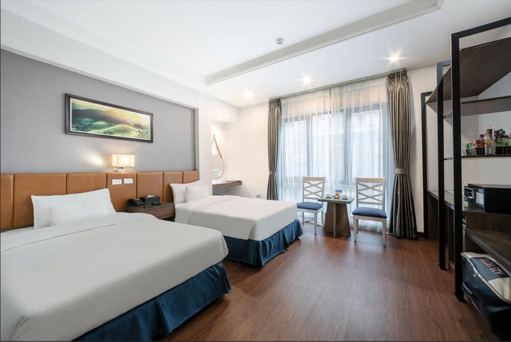 Postel nebo postele na pokoji v ubytování A25 Hotel - 193 Trung Kinh