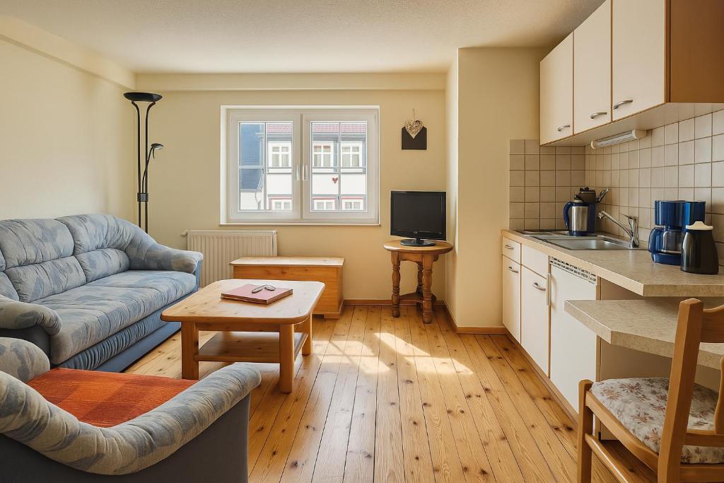 a kitchen and living room with a couch and a table at Moselglocke Urlaub im Herzen von Zell in Zell an der Mosel