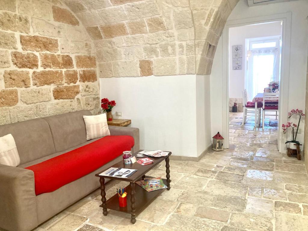a living room with a couch and a table at Antica Pietra in Polignano a Mare