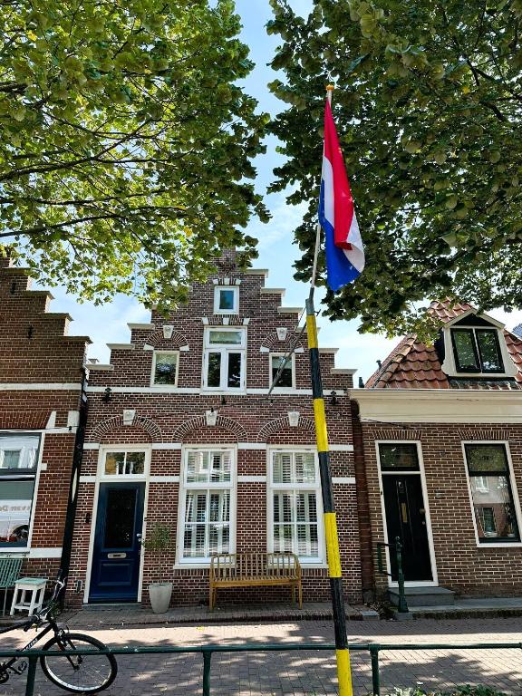 a flag on a pole in front of a building at Beautiful entire house in the center in Medemblik
