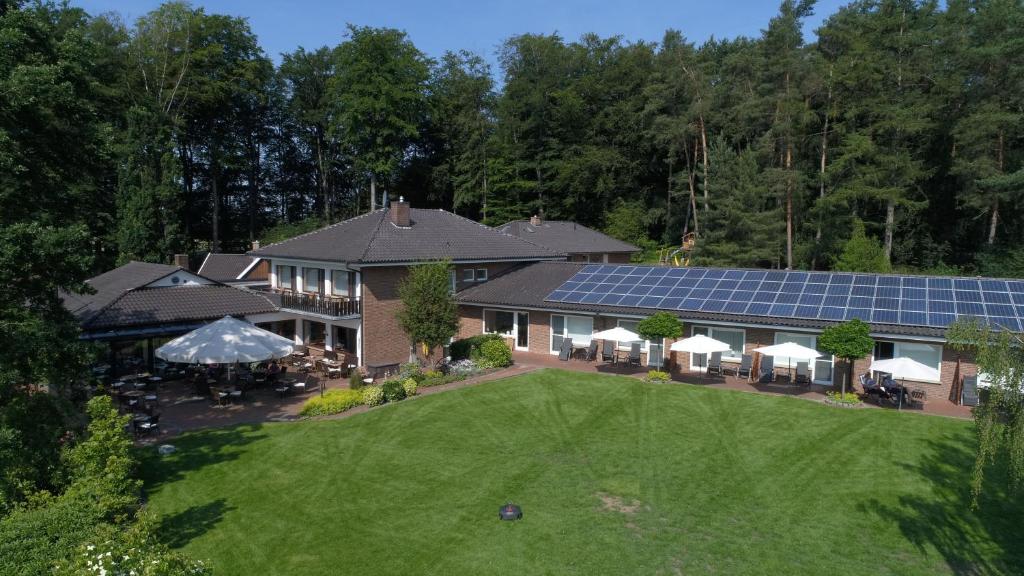 an aerial view of a house with a lawn and solar panels at Hotel Café Wahlde Restaurant in Grapperhausen