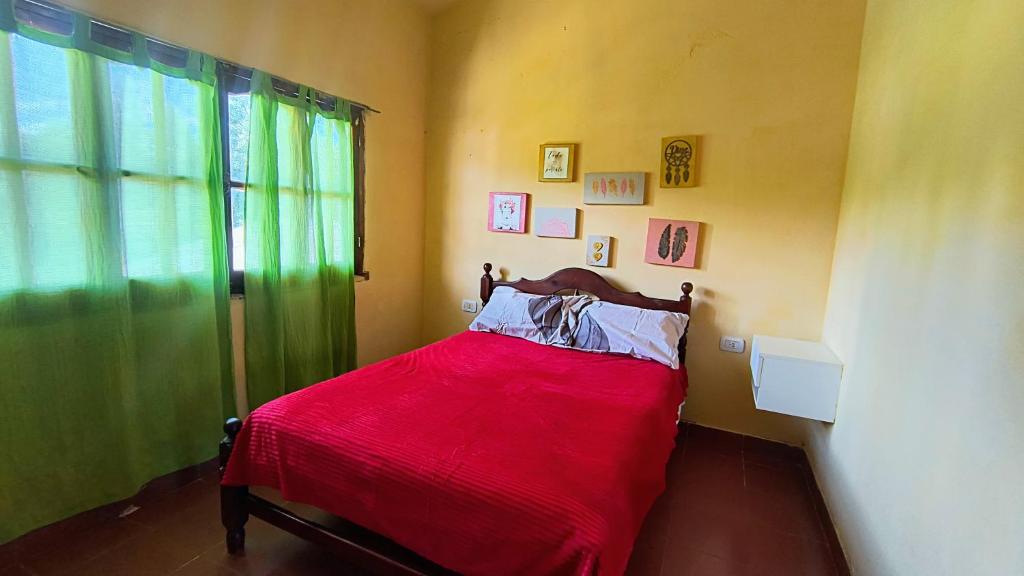 a bedroom with a bed with a red blanket at Jujuy Hub Hostel in Reyes