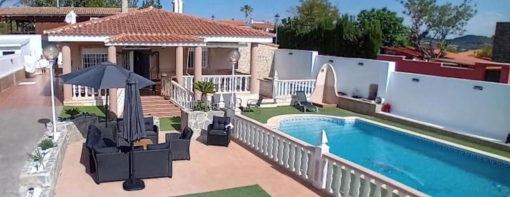 a home with a swimming pool and a house at Villa entre terre et mer in Montroy