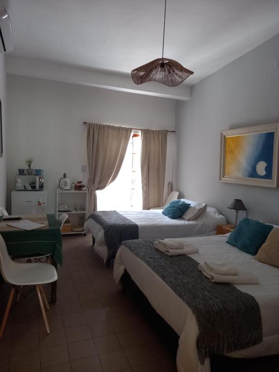 a bedroom with three beds and a window at Linas Apart & Suite in La Rioja