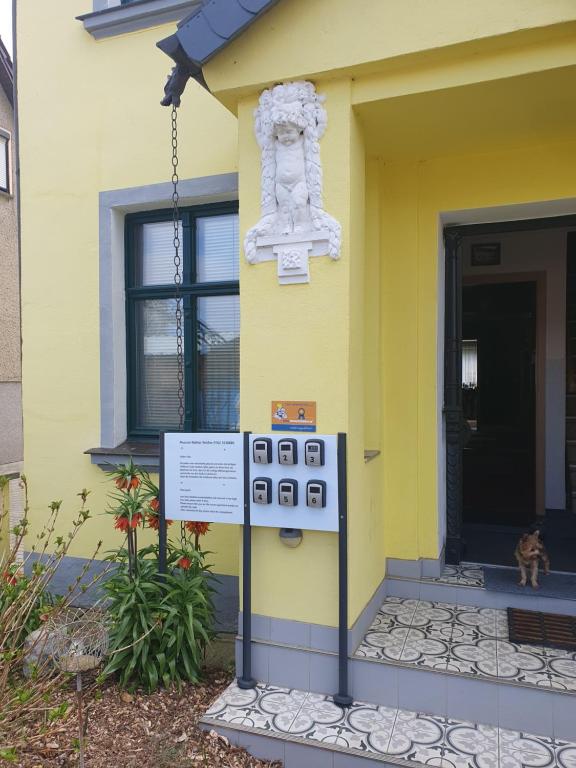 a yellow house with a sign in front of it at Pension Mahler wir sind günstig, zwischen Wittenberge, Perleberg, Kyritz, Heiligengrabe, Pritzwalk, Putlitz, Wittstock, , an der A 24 in Kuhbier