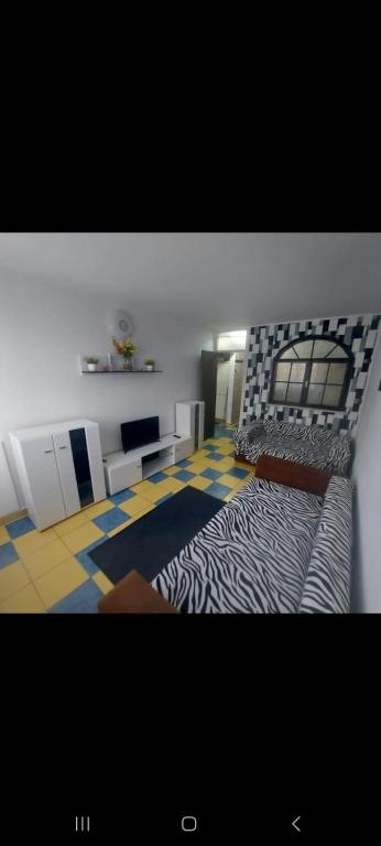 a bedroom with a zebra print bed in a room at Olimp SeaSun in Olimp