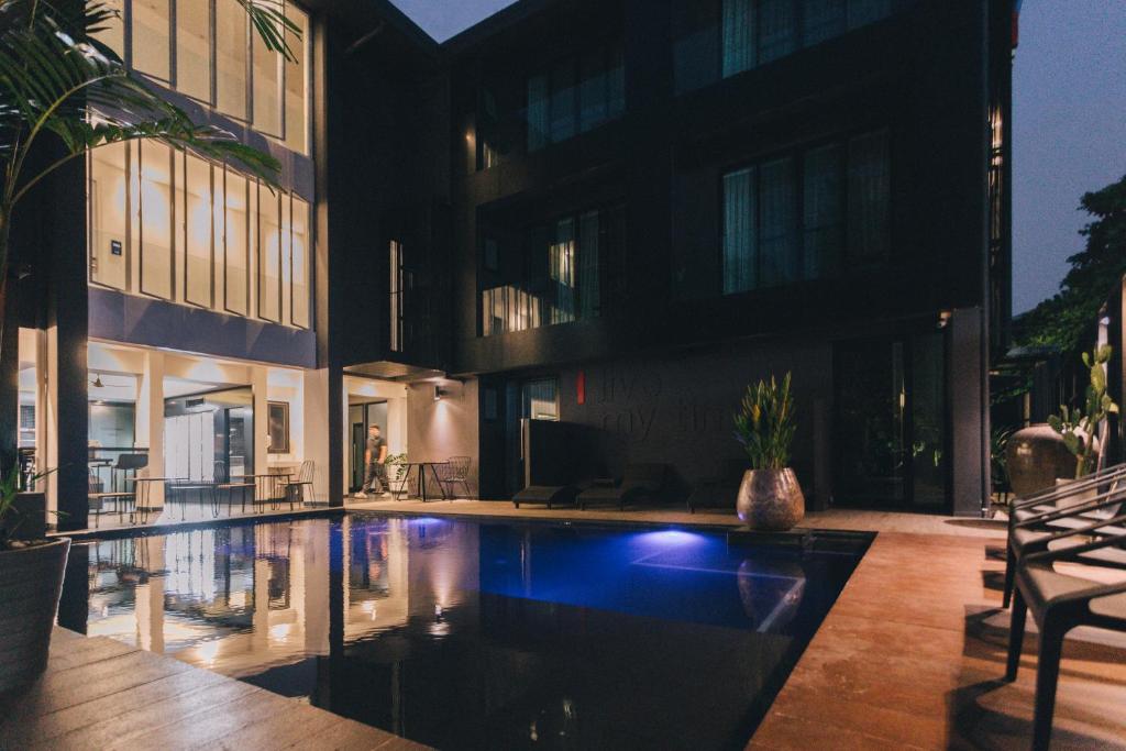 A small illuminated courtyard pool beside the hotel building.