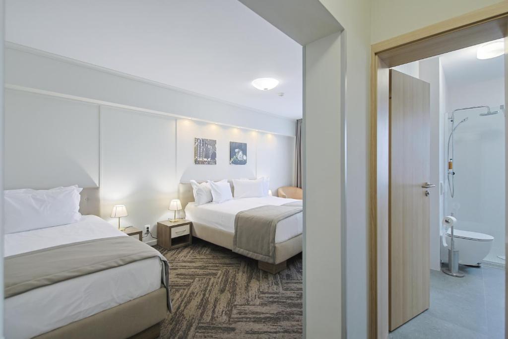 Postel nebo postele na pokoji v ubytování Potaissa Hotel