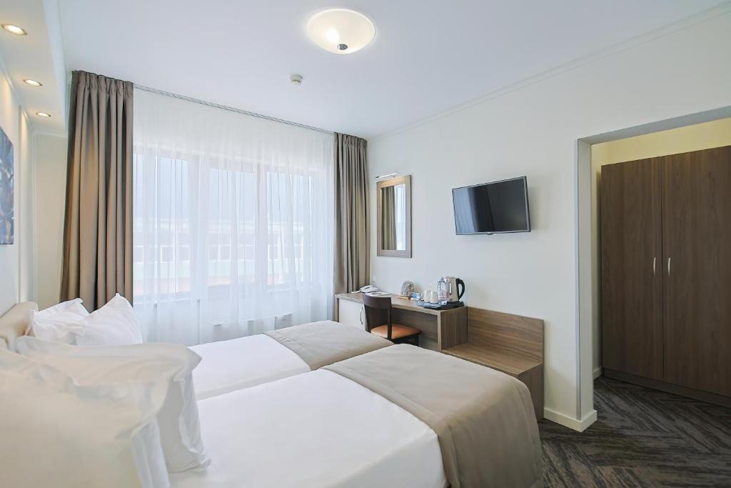 Postel nebo postele na pokoji v ubytování Potaissa Hotel