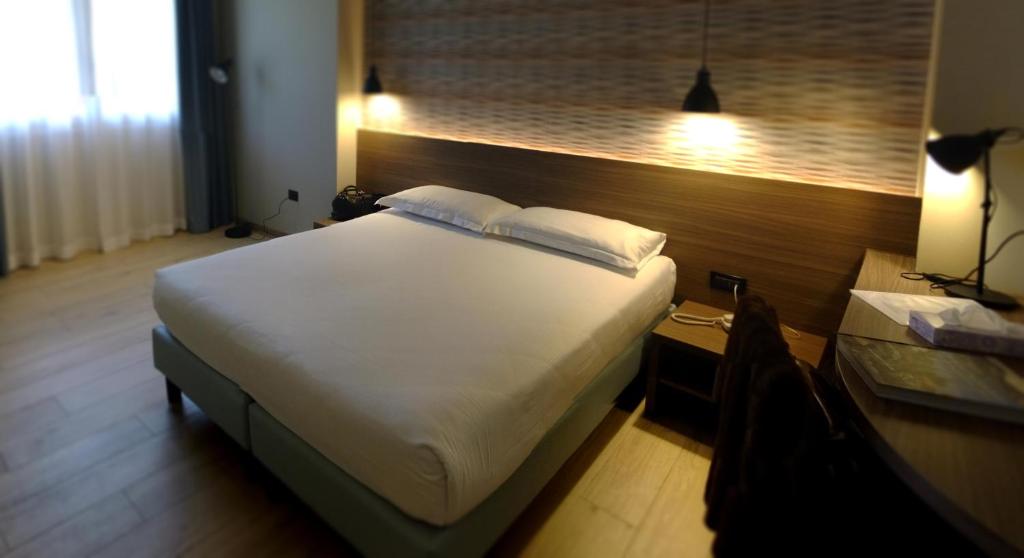 Postel nebo postele na pokoji v ubytování Hotel Ambra