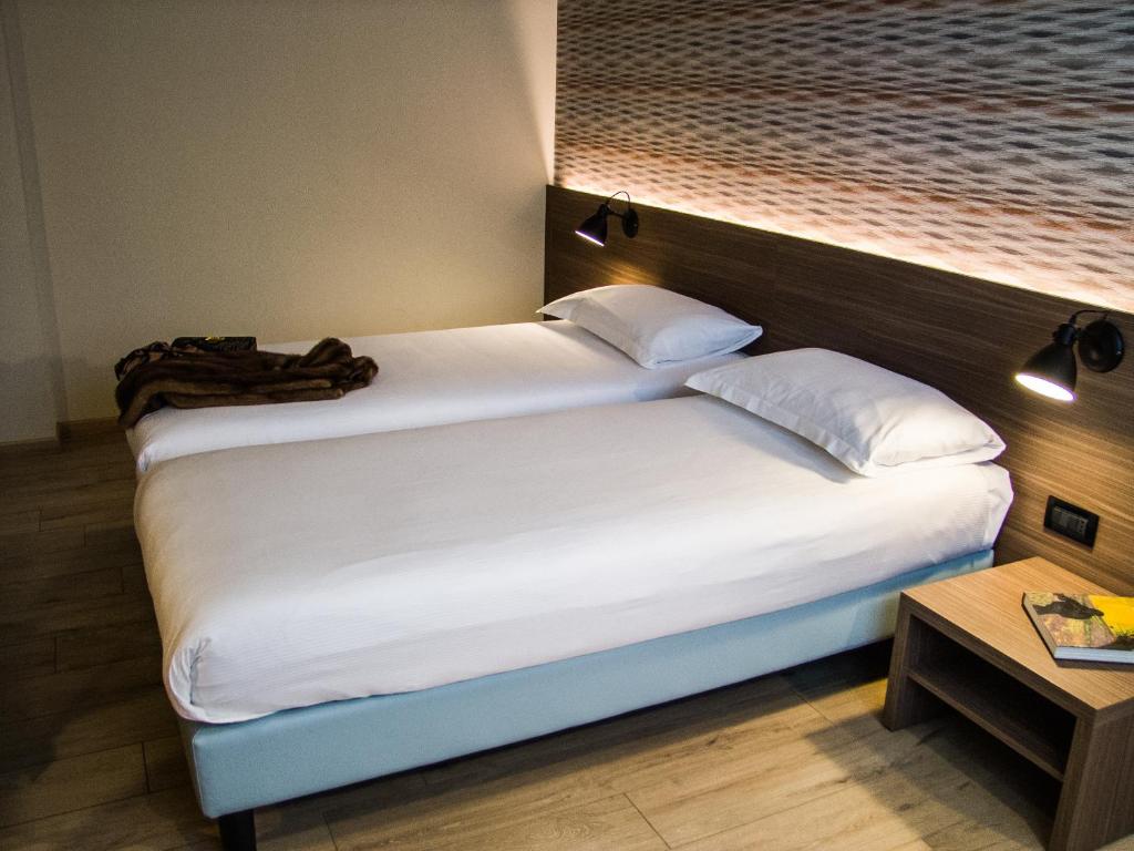 Postel nebo postele na pokoji v ubytování Hotel Ambra