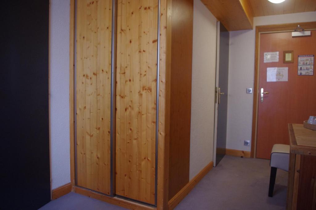 a large wooden door in a room with a desk at Hôtel Le Refuge in Tignes