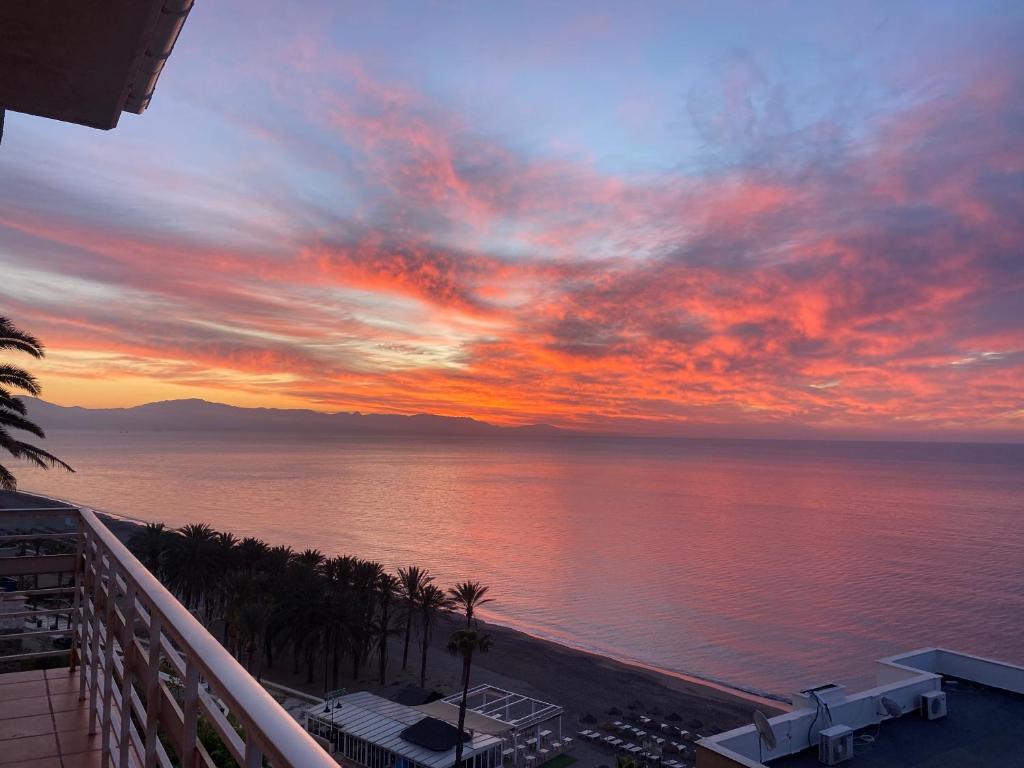 トレモリノスにあるLa Roca Suite Balcón al marのリゾートのバルコニーから夕日の景色を望めます。