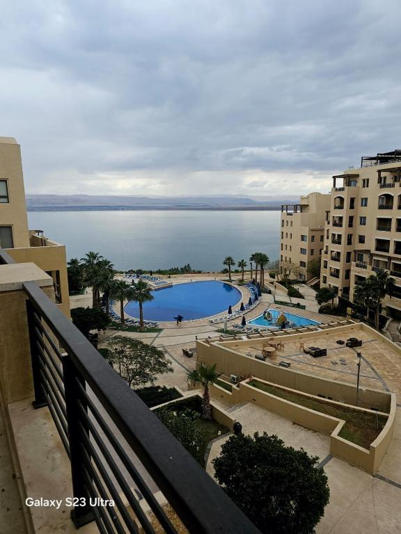 a view of a swimming pool from a balcony at C32 Samarah Resort LOFT apartment in Sowayma