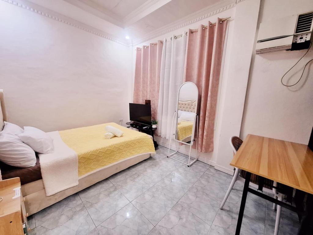 a small bedroom with a bed and a mirror at N2 Studio Room Apartment Transient House Ground Floor walking distance to Abreeza Mall, USEP, SM Lanang in Davao City