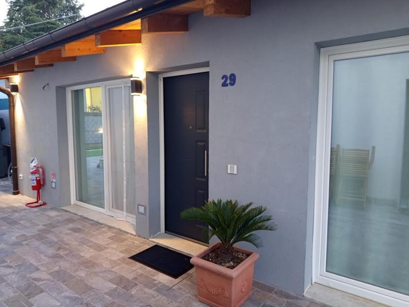 a house with a potted plant in front of a door at Iris Cottage in Anzola dell'Emilia