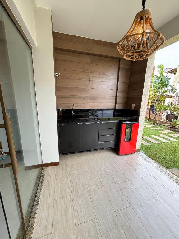 a kitchen with wooden cabinets and a chandelier at villa privilege ap 01 in Marau