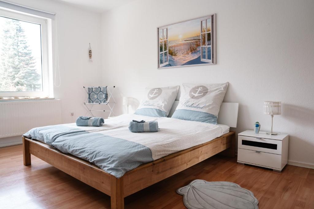 a bedroom with a large bed with blue pillows on it at Sunny Maritime Apartment near Hannover central station in Hannover